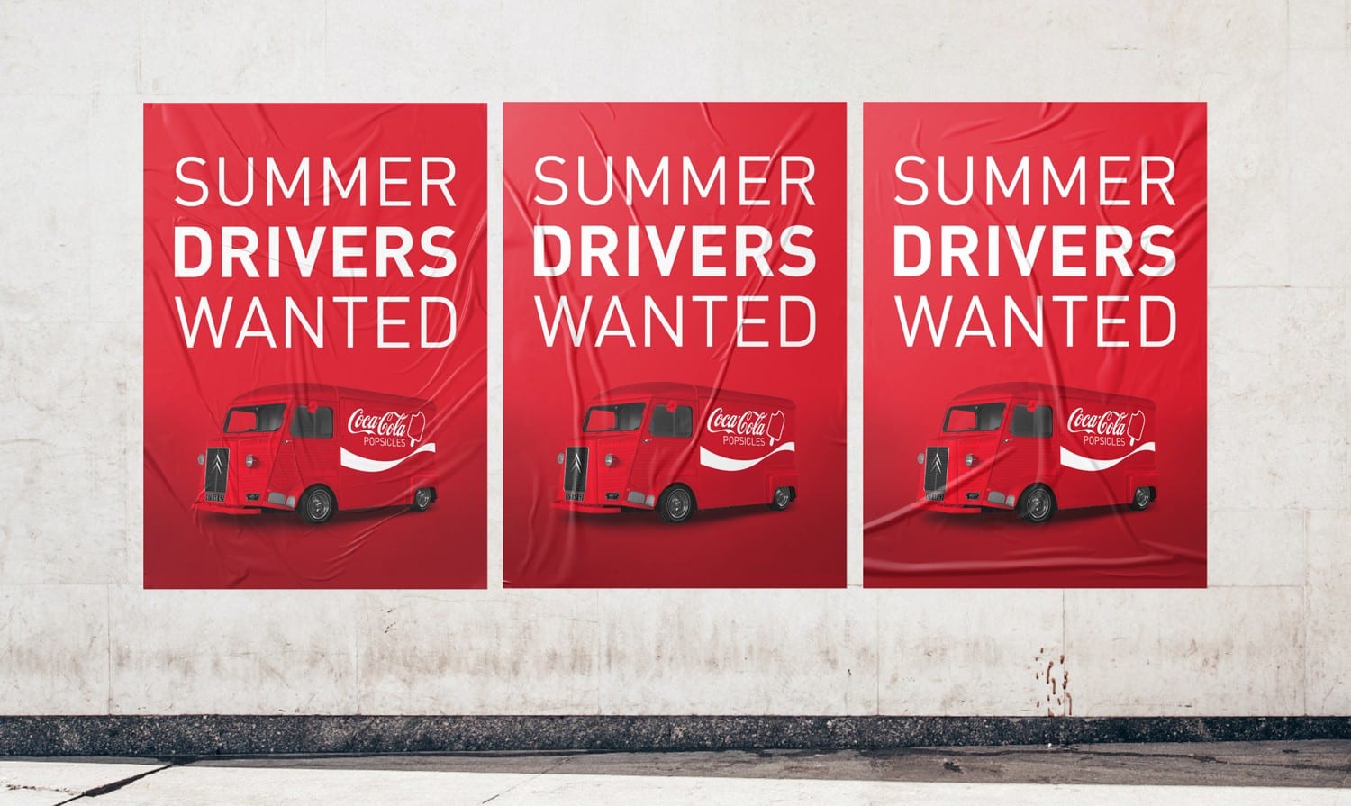 Three Summer Drivers Wanted posters pasted side by side on a concrete wall, each in Coca-Cola red with the branded Coca-Cola Popsicles truck beneath the headline